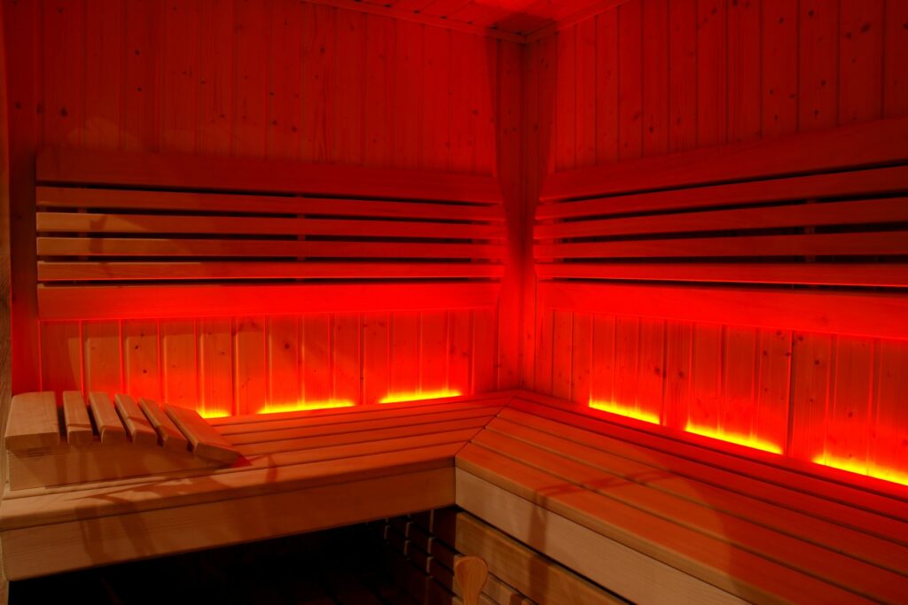 Photo of red light against wooden walls of a sauna