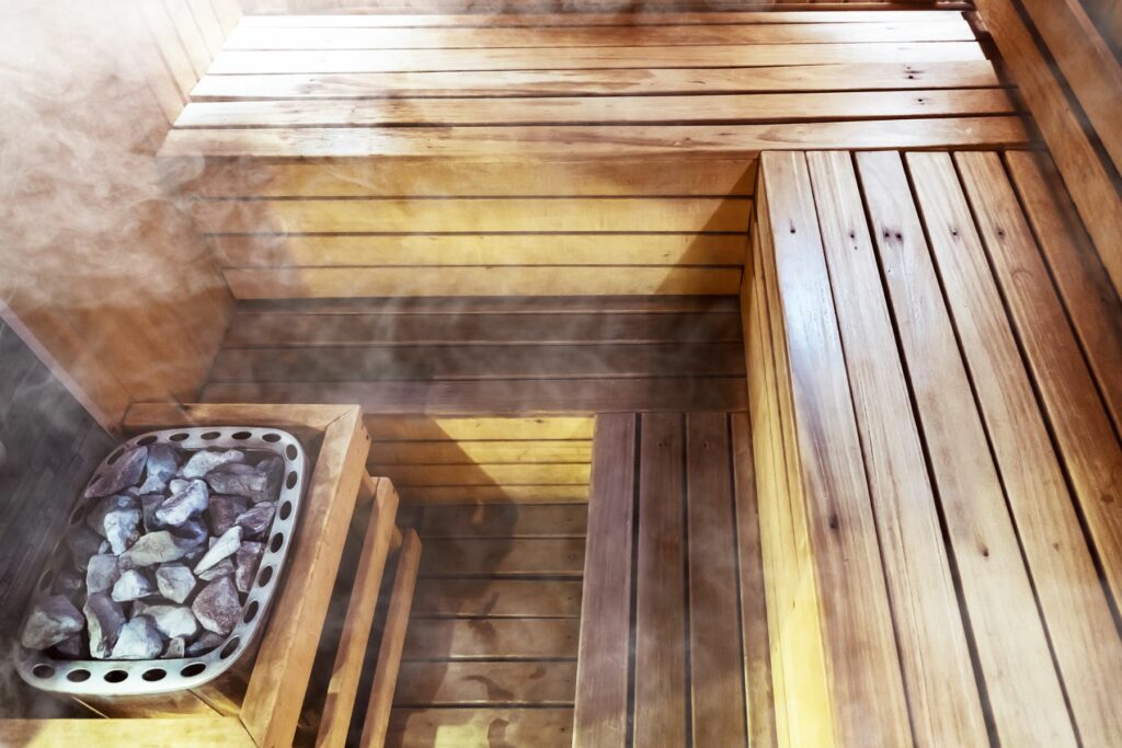 Photo of traditional wooden sauna with hot coals and steam