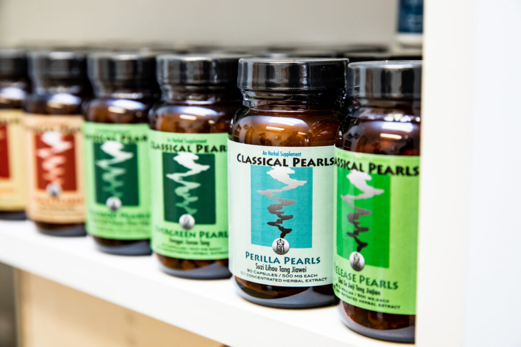 Shelf lined with herbal supplement bottles